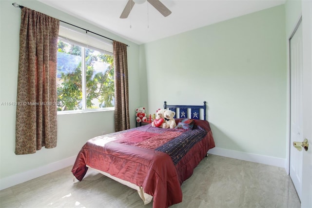 bedroom featuring ceiling fan and baseboards