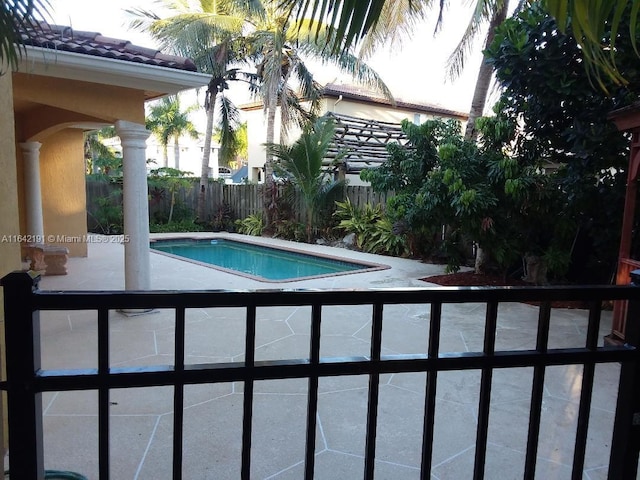 view of pool with a fenced in pool and fence