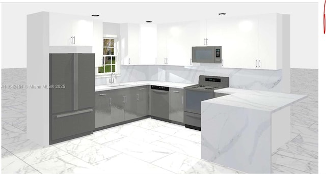 kitchen featuring stainless steel appliances, a sink, white cabinetry, marble finish floor, and decorative light fixtures