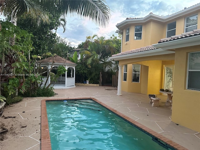 outdoor pool with a patio area and a gazebo