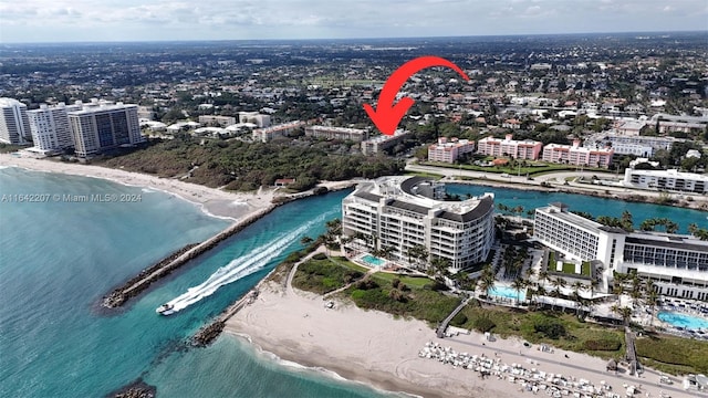 drone / aerial view featuring a water view and a beach view