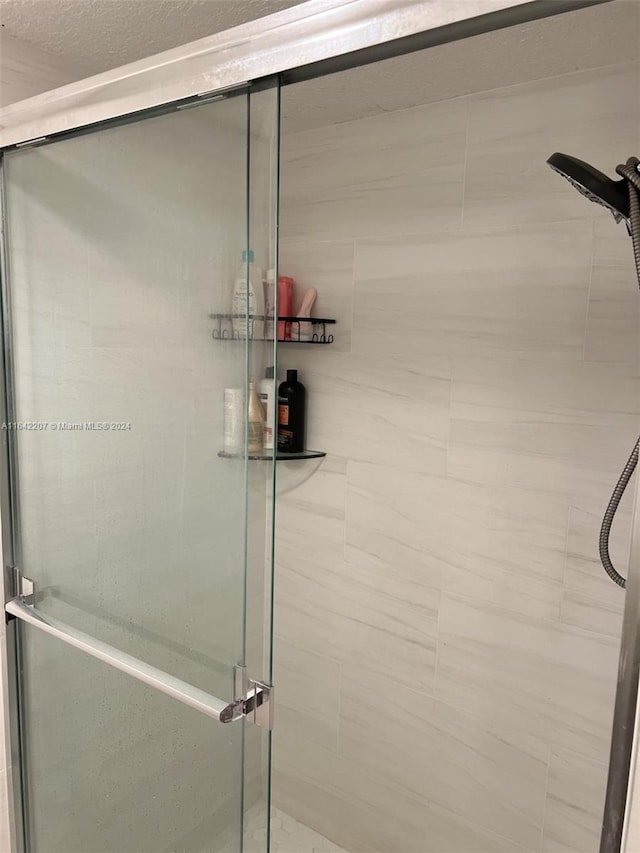 bathroom with a shower with shower door