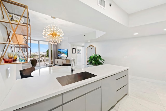 kitchen featuring a notable chandelier, sink, light tile patterned floors, and gray cabinetry