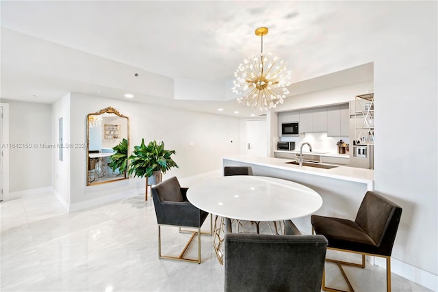 dining space featuring a notable chandelier, light tile patterned floors, and sink