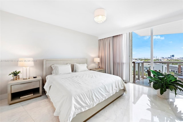 bedroom featuring light tile patterned floors, expansive windows, and access to exterior