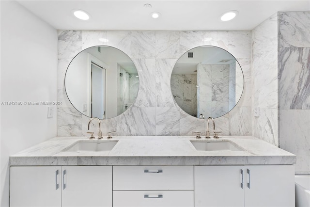 bathroom featuring tile walls, backsplash, and double vanity