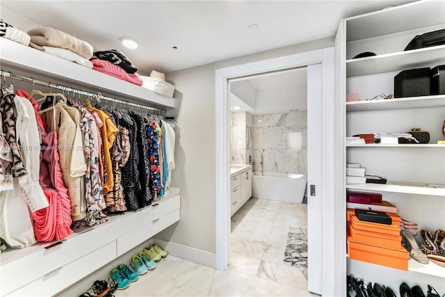 walk in closet with light tile patterned floors