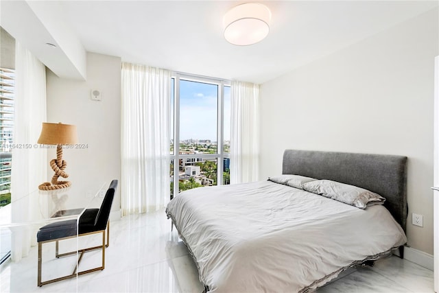 bedroom featuring floor to ceiling windows and light tile patterned flooring