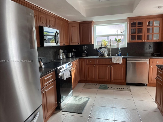 20042 W Lake Dr, Hialeah, FL 33015 - kitchen with stainless steel appliances, tasteful backsplash, glass insert cabinets, and dark countertops