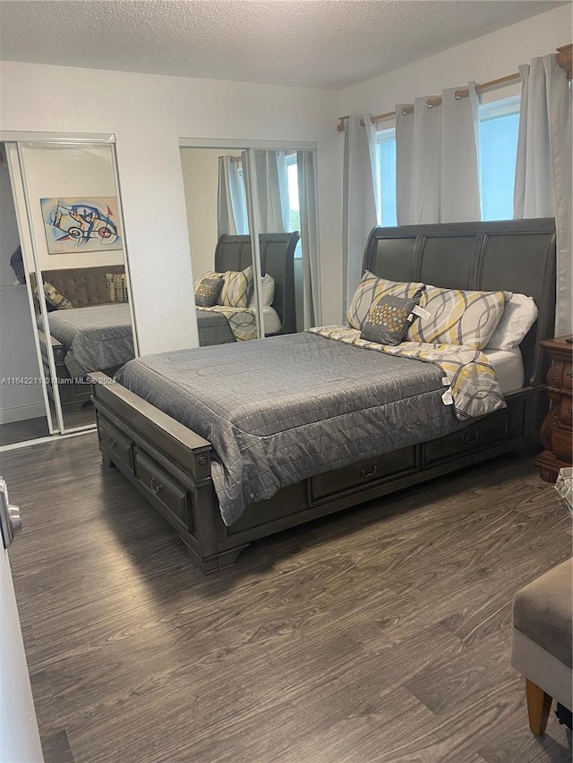 20042 W Lake Dr, Hialeah, FL 33015 - bedroom featuring wood finished floors, two closets, and a textured ceiling
