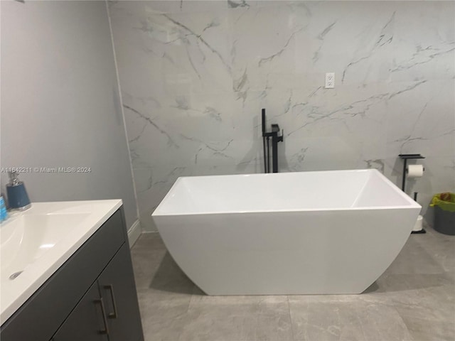 20042 W Lake Dr, Hialeah, FL 33015 - bathroom with vanity, a freestanding tub, marble finish floors, and baseboards