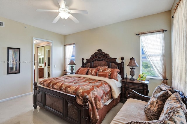 bedroom featuring ensuite bath, light tile patterned flooring, and ceiling fan