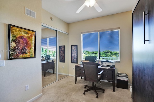 carpeted office space featuring ceiling fan