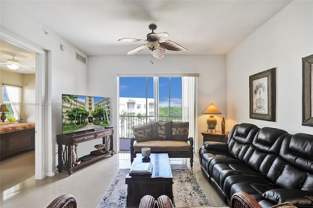 living room featuring ceiling fan, plenty of natural light, and light tile patterned floors