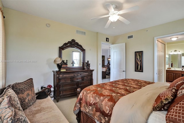 bedroom featuring ceiling fan, ensuite bathroom, and light carpet