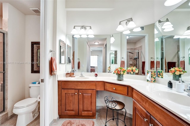 bathroom featuring double vanity, walk in shower, toilet, and tile patterned flooring