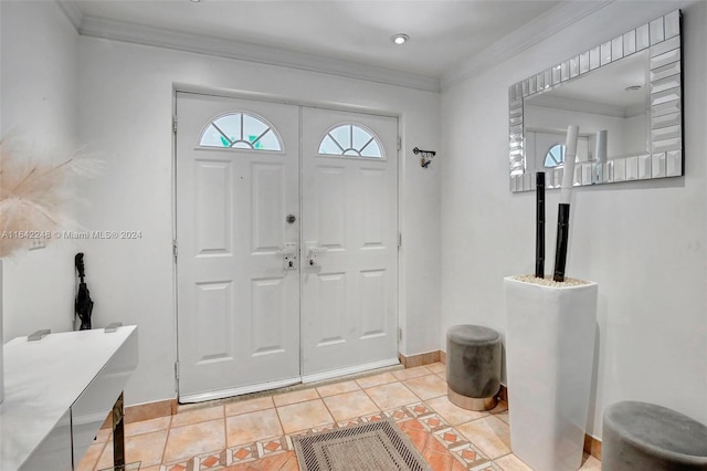 foyer with light tile patterned flooring, baseboards, and ornamental molding