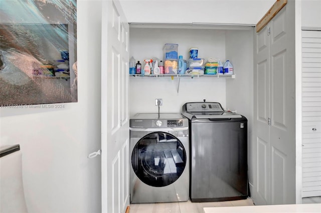 clothes washing area with washer and dryer and laundry area