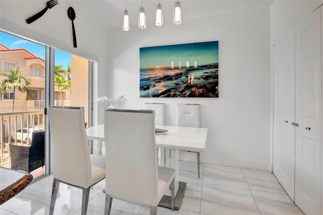 dining space featuring tile patterned floors and baseboards