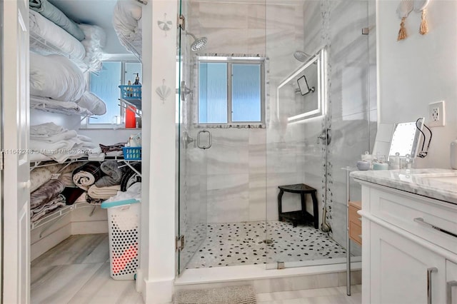 full bath with a shower stall and vanity