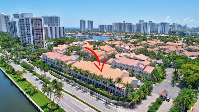 birds eye view of property featuring a water view and a city view