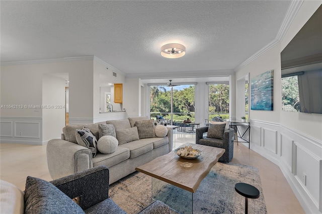 living room with a healthy amount of sunlight, ornamental molding, and a textured ceiling