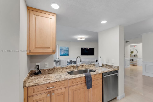 kitchen with a textured ceiling, light brown cabinetry, ornamental molding, dishwasher, and sink