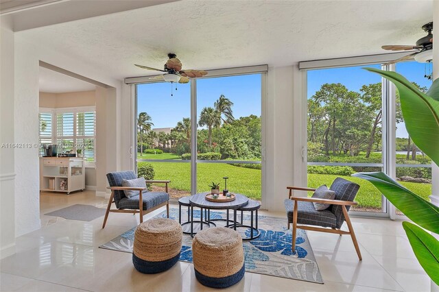 sunroom featuring ceiling fan