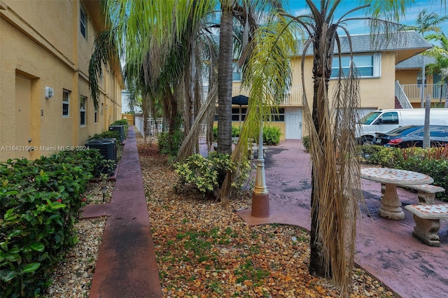 view of yard featuring fence and central AC