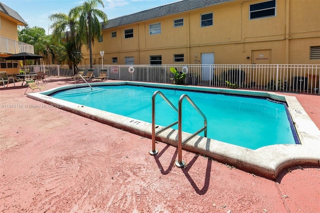 pool featuring a patio area and fence