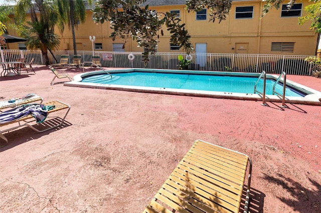 pool featuring a patio and fence