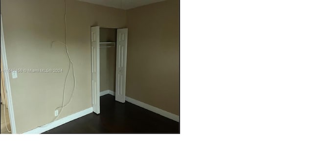 unfurnished bedroom featuring a closet and baseboards