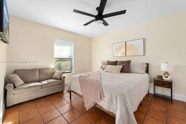 tiled bedroom featuring ceiling fan