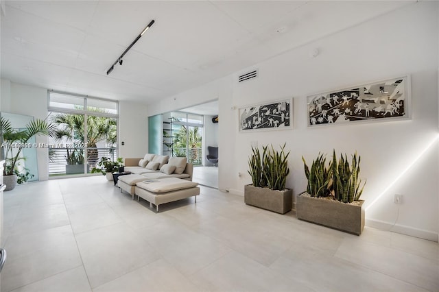 tiled living room with expansive windows and track lighting