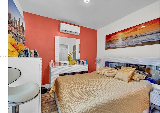 bedroom featuring hardwood / wood-style flooring and an AC wall unit