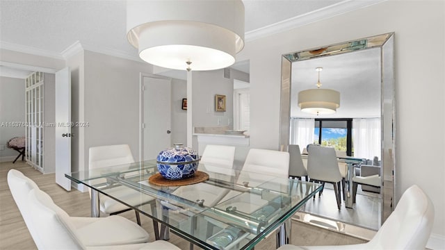 dining area with visible vents, ornamental molding, and light wood finished floors