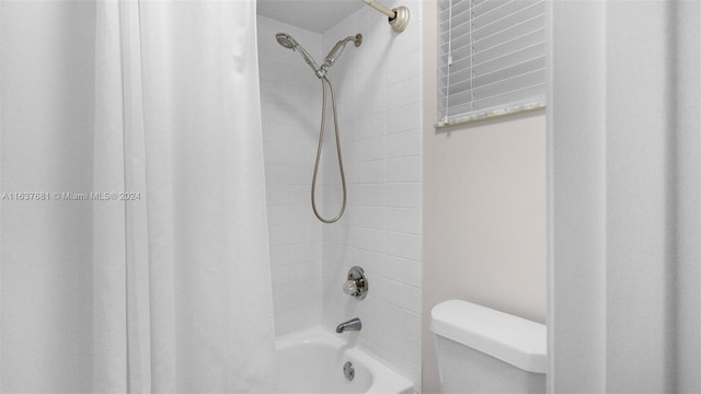 bathroom with shower / tub combo and toilet