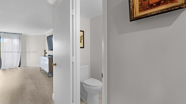 bathroom with toilet and wood finished floors