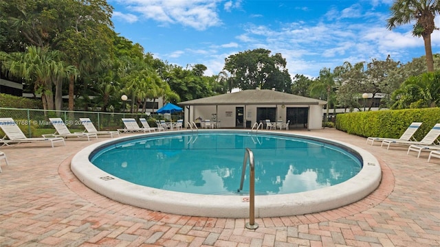 pool featuring a patio and fence