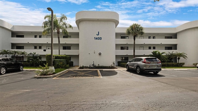 view of building exterior with uncovered parking