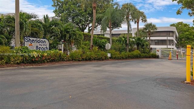 exterior space featuring traffic signs, a gate, and a gated entry