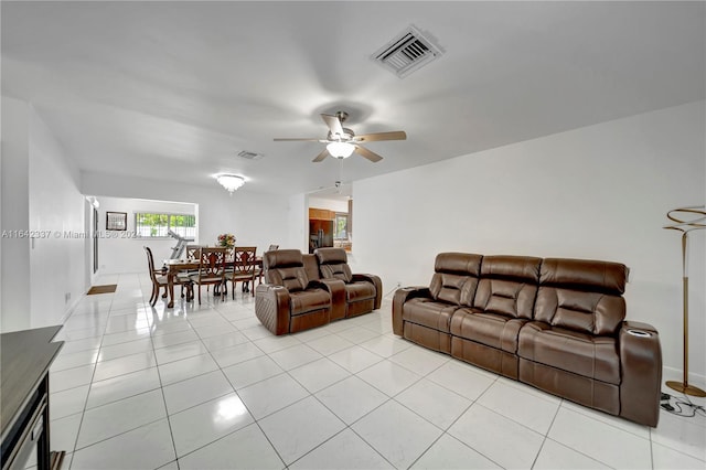 tiled living room with ceiling fan