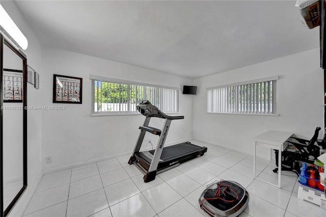 exercise room with light tile patterned floors