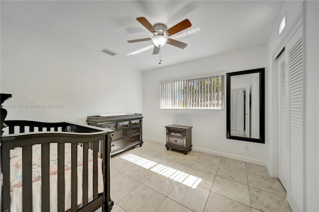 bedroom featuring a closet, ceiling fan, and light tile patterned flooring