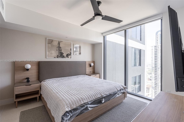 tiled bedroom featuring ceiling fan and access to outside