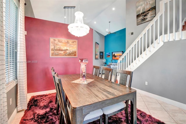 tiled dining area with a notable chandelier and high vaulted ceiling