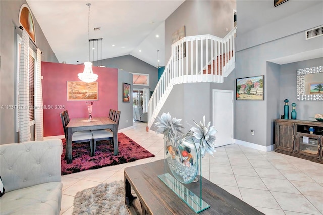 living room featuring light tile patterned floors and high vaulted ceiling