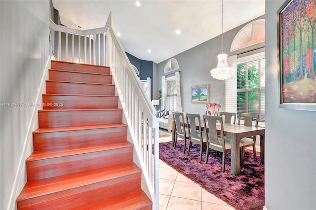 staircase featuring tile patterned floors and an inviting chandelier