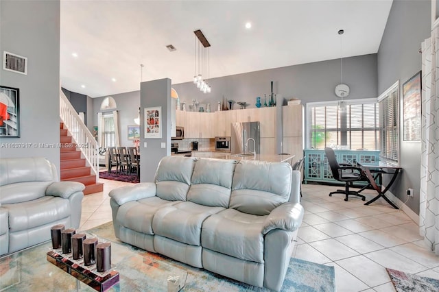 tiled living room with a towering ceiling