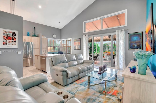 living room with sink, high vaulted ceiling, light tile patterned flooring, and french doors